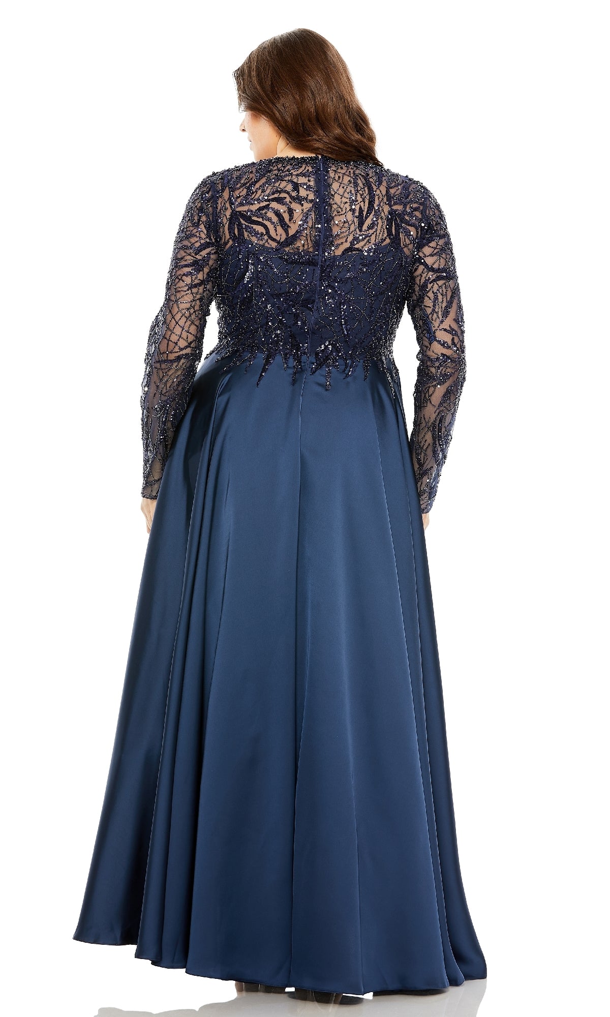 A woman faces away, wearing the Mac Duggal 20619 Plus-Size Long Blue Formal Dress featuring a lace and sequin bodice with sheer long sleeves.